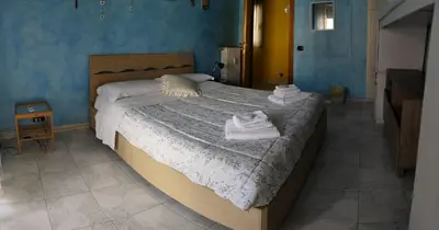 a bedroom with a large bed with towels on it at B&B trastevere 2 in Rome