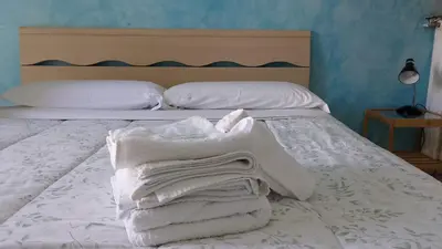 a bedroom with a bed with white towels on it at B&B trastevere 2 in Rome