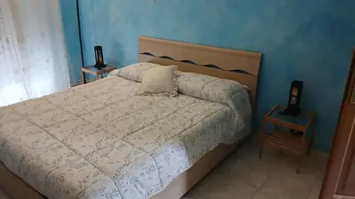 a bedroom with a white bed with two night stands at B&B trastevere 2 in Rome