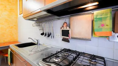 a kitchen with a sink and a stove top oven at La Casa che Vorrei in Rome