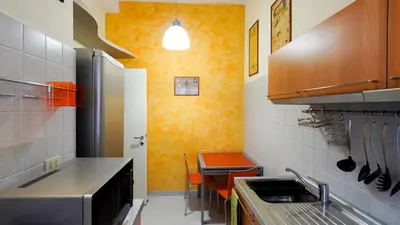 a small kitchen with a sink and a table at La Casa che Vorrei in Rome