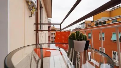 a glass table on a balcony with a plant at La Casa che Vorrei in Rome