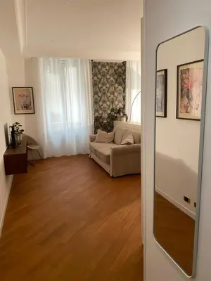 a living room with a couch and a mirror at LovingRome Colosseum in Rome