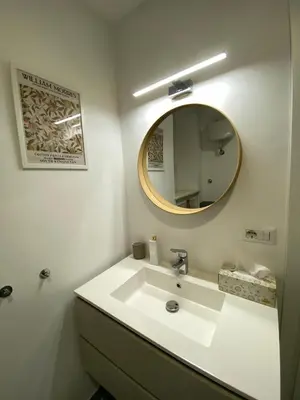a bathroom with a white sink and a mirror at LovingRome Colosseum in Rome