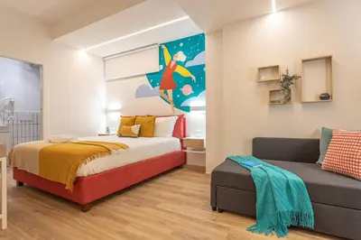a bedroom with a bed and a couch at Le Muse Suites in Rome