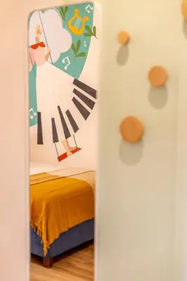 a bedroom with a painting of a woman on the wall at Le Muse Suites in Rome