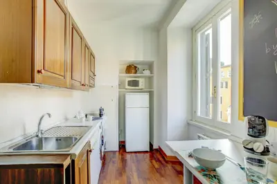a kitchen with a sink and a refrigerator at Colosseo MecenArt 77 - Home and More in Rome