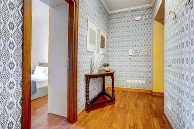 a hallway with a table in a room at Colosseo MecenArt 77 - Home and More in Rome