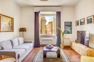 a living room with a couch and a tv at Colosseo MecenArt 77 - Home and More in Rome