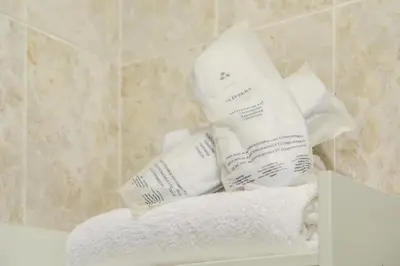 a pile of towels sitting on a shelf in a bathroom at Colosseo MecenArt 77 - Home and More in Rome