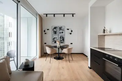 a kitchen and dining room with a table and chairs at San Lorenzo Labicana Luxury Apartment in Rome
