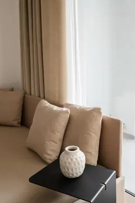 a vase sitting on a table in front of a couch at San Lorenzo Labicana Luxury Apartment in Rome