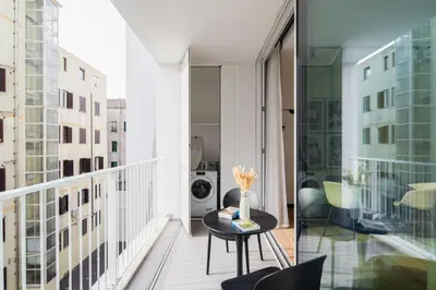 a balcony with a table and a washing machine at San Lorenzo Labicana Luxury Apartment in Rome