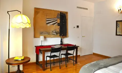 a room with a desk with two chairs and a table at Trastevere Advenida in Rome