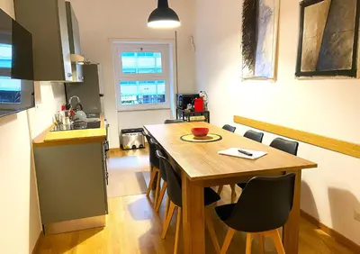 a kitchen and dining room with a wooden table and chairs at Trastevere Advenida in Rome