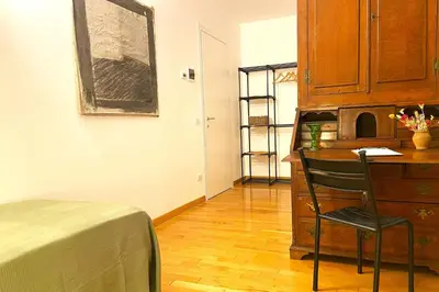 a bedroom with a desk and a chair in a room at Trastevere Advenida in Rome