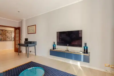 a living room with a flat screen tv on a wall at Elegant Home San Pietro vicino alla Metro in Rome