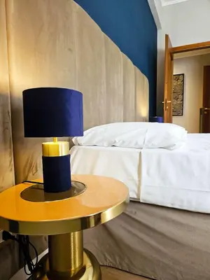 a bedroom with a bed and a table with a lamp at Elegant Home San Pietro vicino alla Metro in Rome