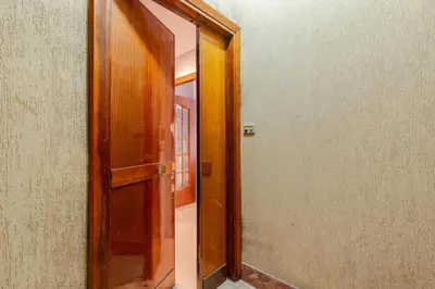 an open wooden door in a room with a hallway at Elegant Home San Pietro vicino alla Metro in Rome