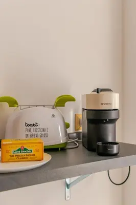 a counter top with a coffee maker and a toaster at Elegant Home San Pietro vicino alla Metro in Rome