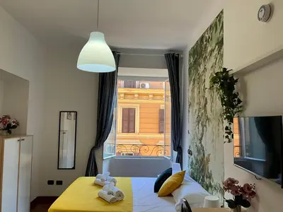 a bedroom with a bed and a large window at Maria House Saint Peter in Rome