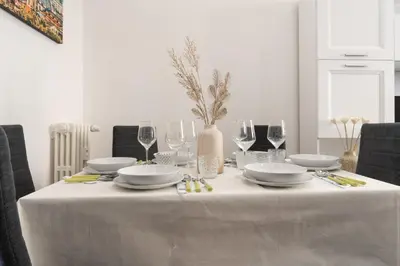 a table with a white table cloth and wine glasses at Casa Romana Vaticano-Metro in Rome