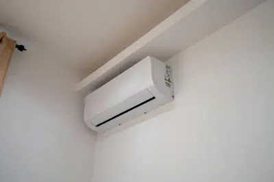 a white air conditioner on a wall in a room at Casa Romana Vaticano-Metro in Rome