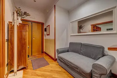 a living room with a couch and a mirror at Vatican Luxury Suite Bragadin in Rome