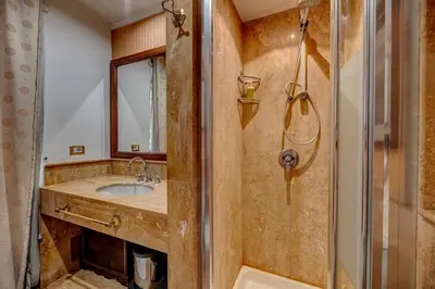 a bathroom with a sink and a shower at Vatican Luxury Suite Bragadin in Rome