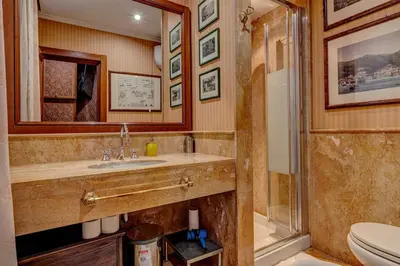 a bathroom with a sink and a shower and a toilet at Vatican Luxury Suite Bragadin in Rome