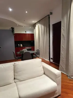 a living room with a white couch and a table at Balduina 225 in Rome