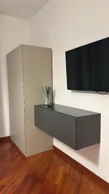 a entertainment center with a flat screen tv on a wall at Balduina 225 in Rome