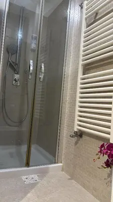 a shower with a glass door in a bathroom at Balduina 225 in Rome