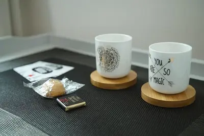 two coffee cups sitting on wooden blocks on a table at FLOUR SUITE - Rome Apartment in Rome