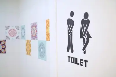 a book with a sign for a toilet at FLOUR SUITE - Rome Apartment in Rome