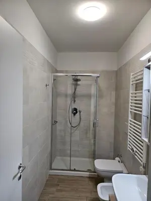 a bathroom with a shower with a toilet and a sink at Two bedrooms with terrace in Rome