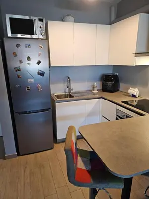 a kitchen with a stainless steel refrigerator with magnets at Two bedrooms with terrace in Rome