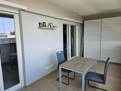 a dining room with a wooden table and chairs at Two bedrooms with terrace in Rome