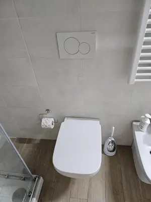 a bathroom with a white toilet and a sink at Two bedrooms with terrace in Rome