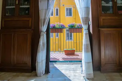an open door with a window with a yellow building at RHome City Garden in Rome
