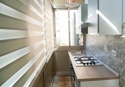 a small kitchen with a stove and a window at RHome City Garden in Rome