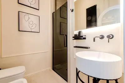a bathroom with a white sink and a shower at Acque Romane Fontana di Trevi M in Rome