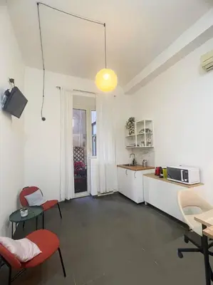 a kitchen with a table and chairs in a room at La casa di raffy in Rome