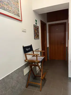 a wooden chair sitting in the corner of a room at La casa di raffy in Rome