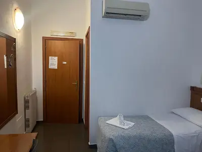 a room with a bed and a door with a towel on it at La casa di raffy in Rome