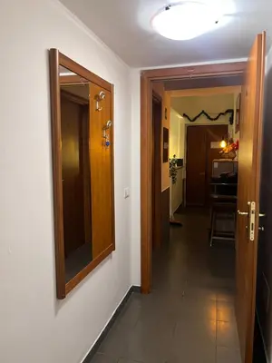 a hallway with a door and a mirror on a wall at La casa di raffy in Rome