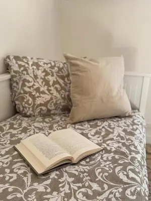 an open book sitting on top of a couch with a pillow at Mopy Apartment in Rome
