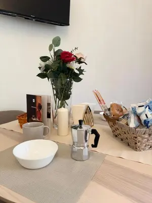 a table with a vase of flowers on a table at Mopy Apartment in Rome