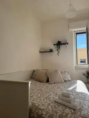 a bedroom with a bed with two towels on it at Mopy Apartment in Rome