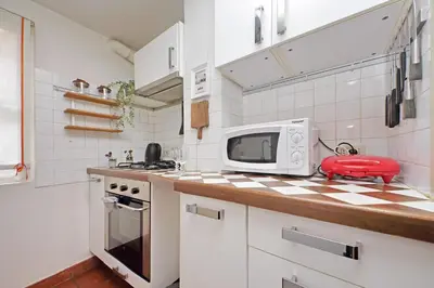 a kitchen with a counter top with a microwave at Cozy Apartment Rione Monti in Rome